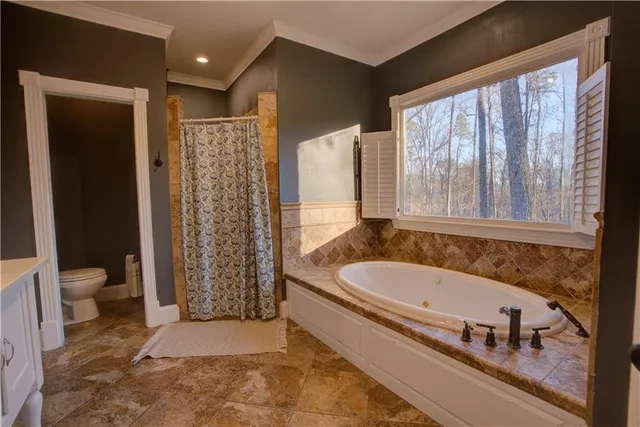a en suite bathroom with a double vanity sink and a mirror