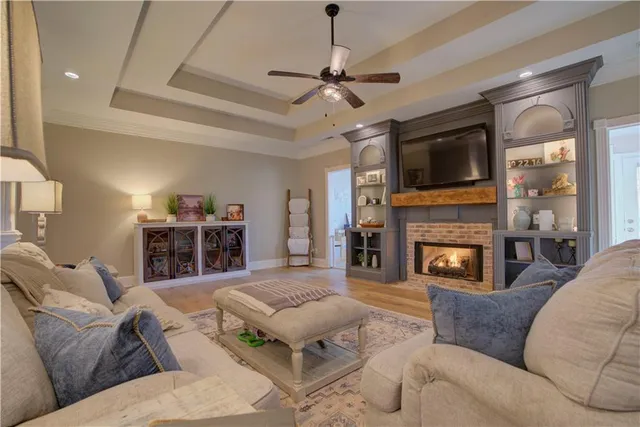 a living room with furniture a fireplace and a flat screen tv