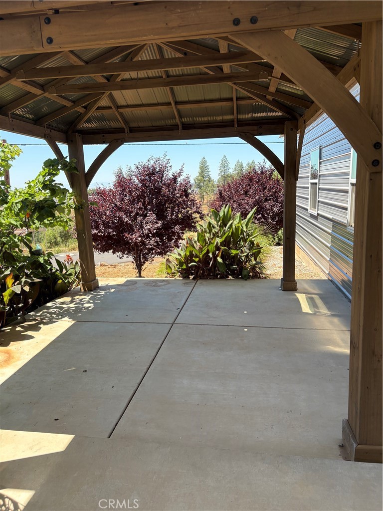5548 Newland Road Paradise, CA 95969 - Photo 12 of 23 a view of a patio with table and chairs under an umbrella