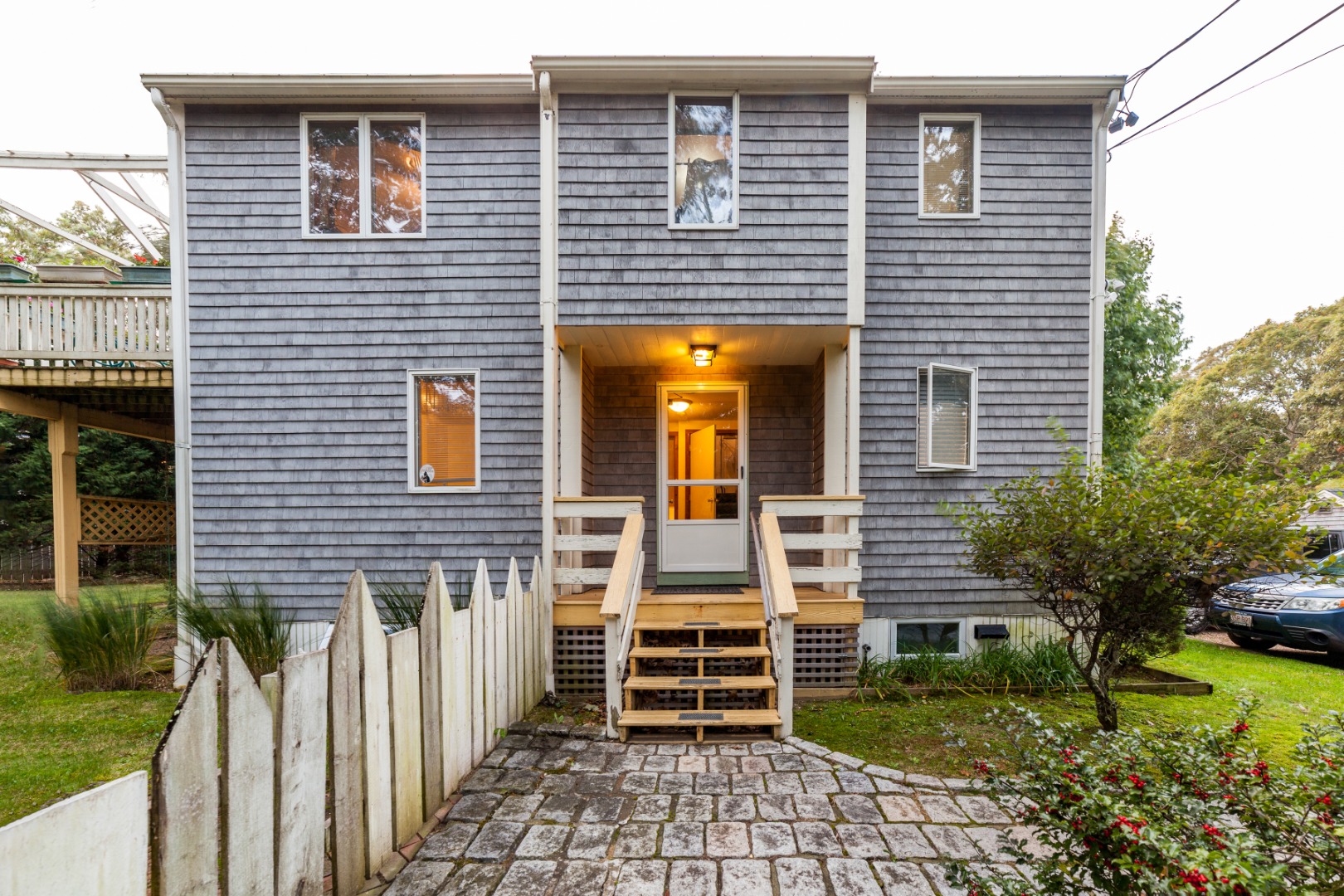 309 County Road Oak Bluffs, MA 02557 - Photo 1 of 32 a front view of a house with a garden