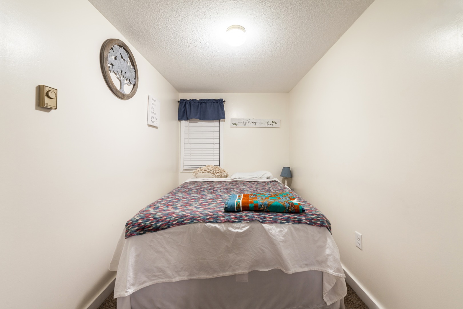 309 County Road Oak Bluffs, MA 02557 - Photo 11 of 32 a bedroom with a bed and a chandelier