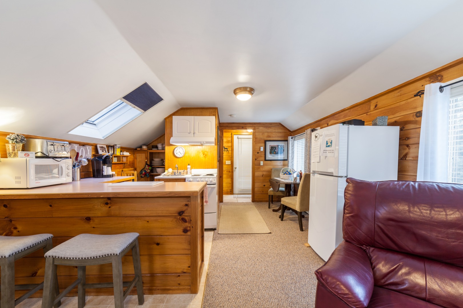 309 County Road Oak Bluffs, MA 02557 - Photo 25 of 32 a living room with a couch and a dining table with wooden floor