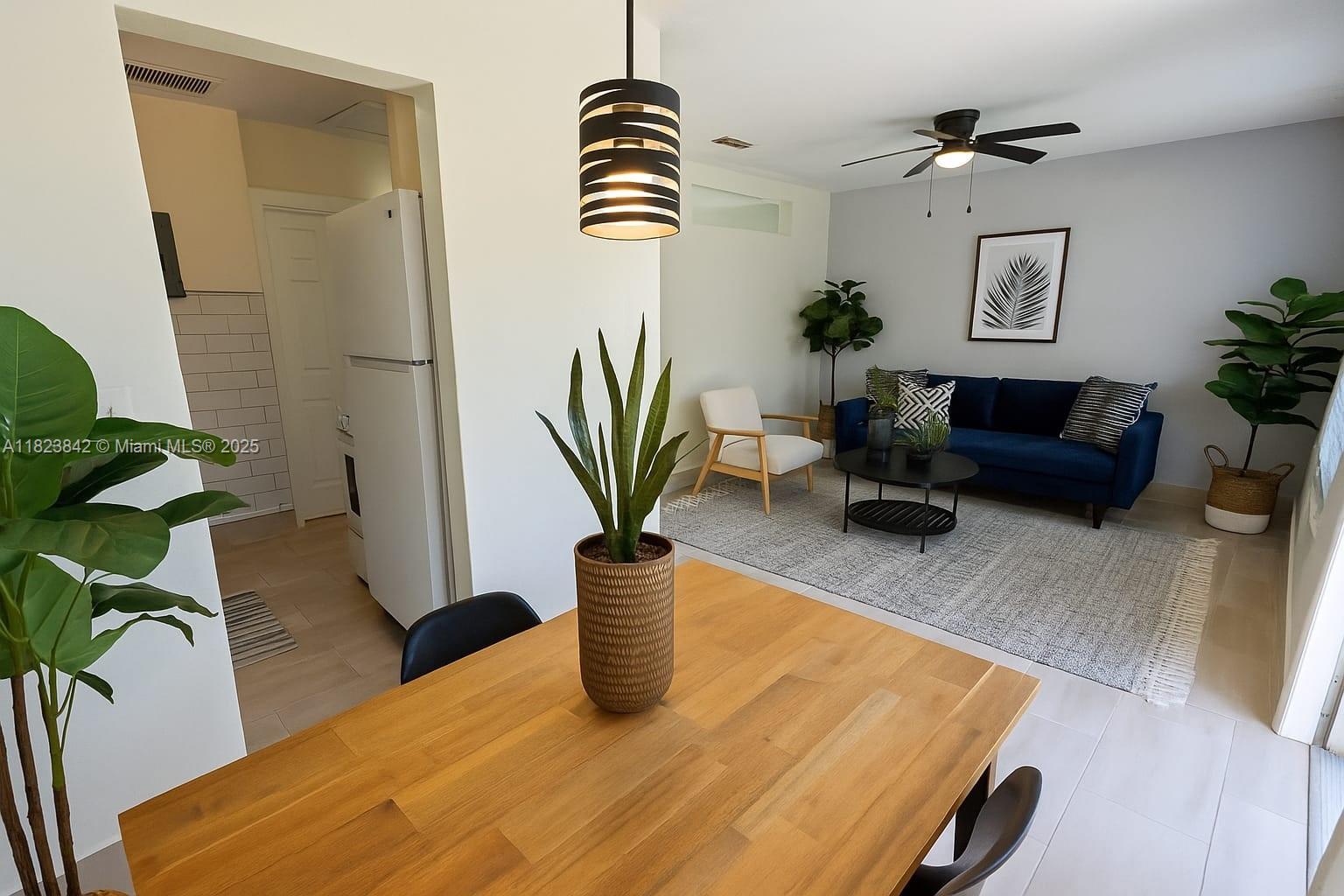 120 Northeast 10th Avenue, Unit 3 Hallandale Beach, FL 33009 - Photo 1 of 11 a dining room with furniture and a potted plant