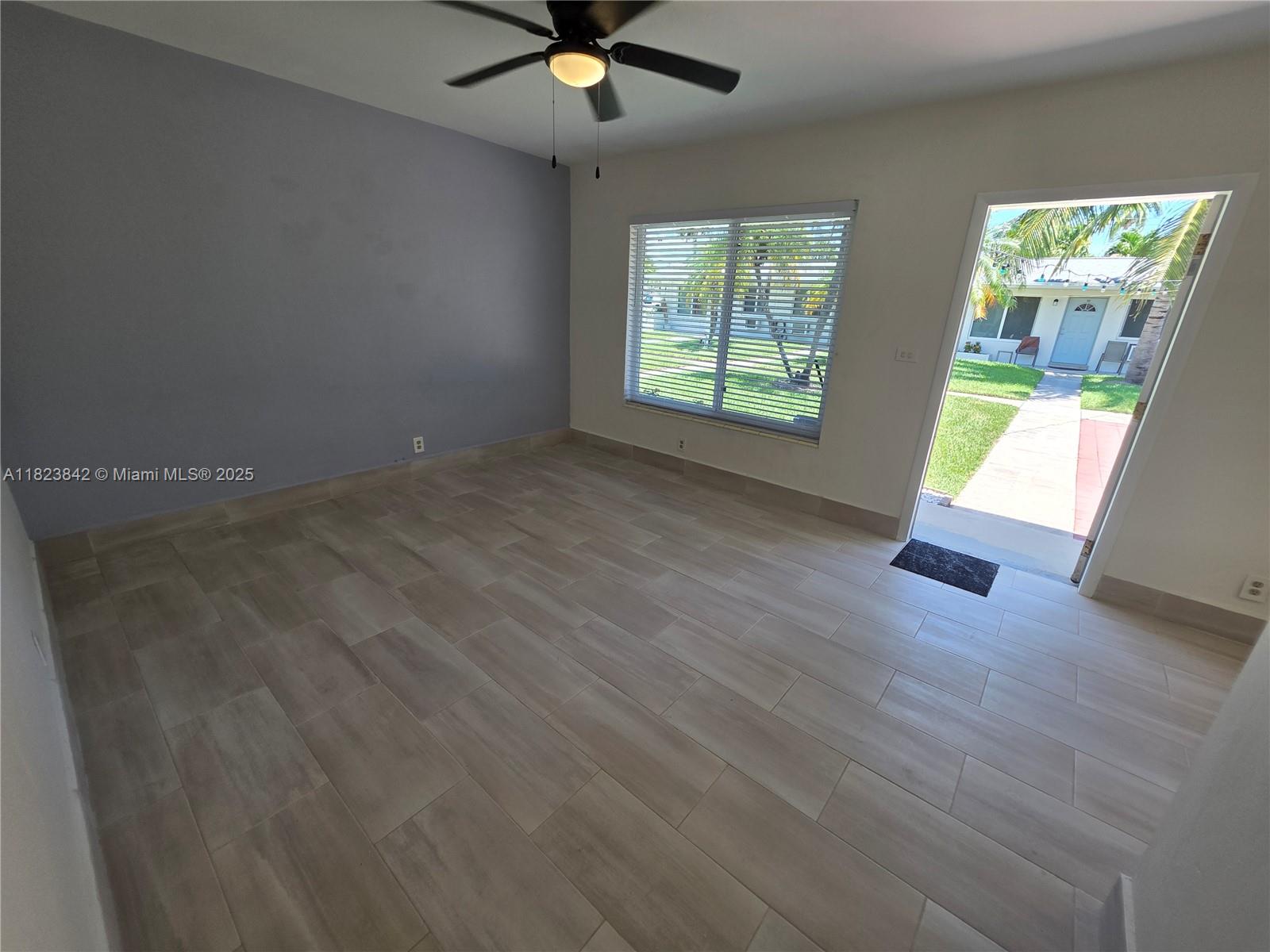 120 Northeast 10th Avenue, Unit 3 Hallandale Beach, FL 33009 - Photo 5 of 11 an empty room with windows