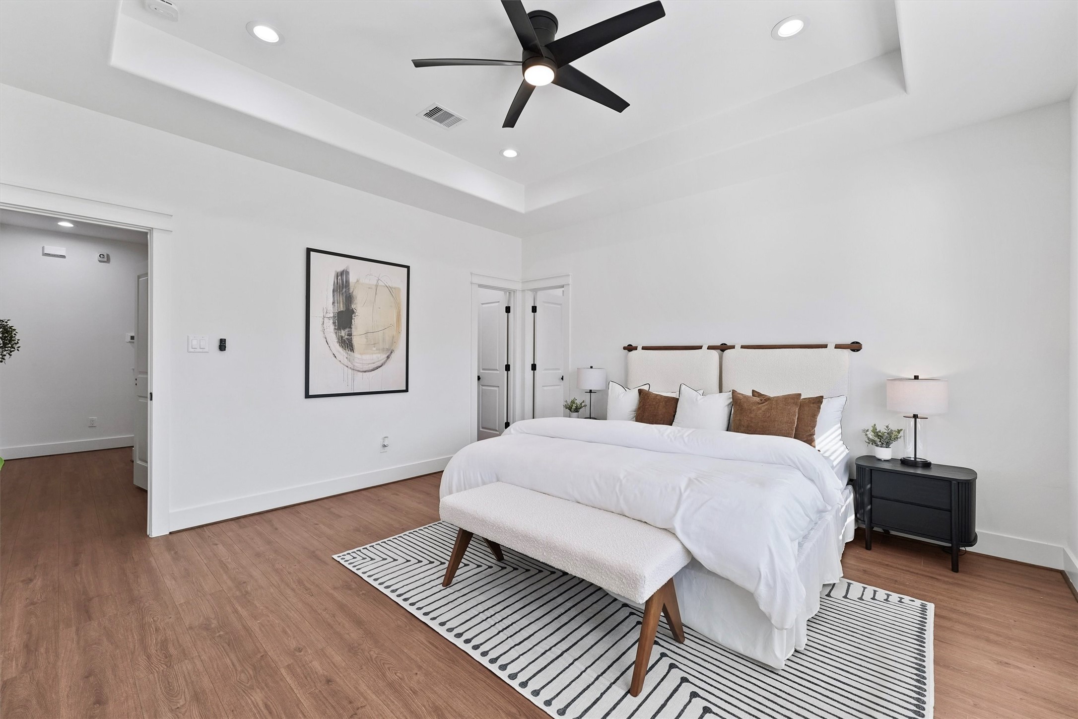 6130 Endeavor Heights Road Houston, TX 77091 - Photo 12 of 33 a bedroom with a bed and wooden floor