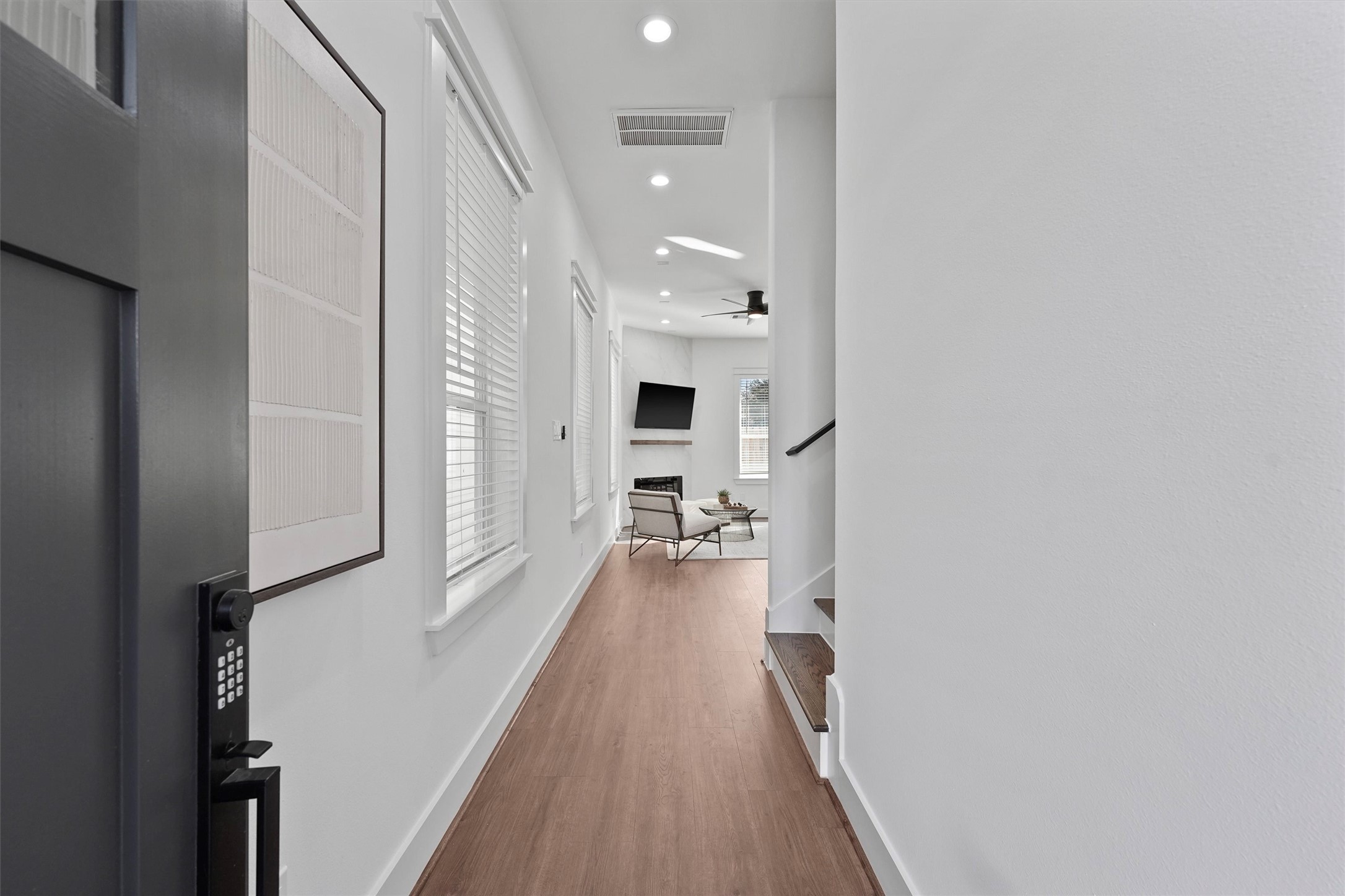 6130 Endeavor Heights Road Houston, TX 77091 - Photo 3 of 33 a view of a hallway view with wooden floor and staircase