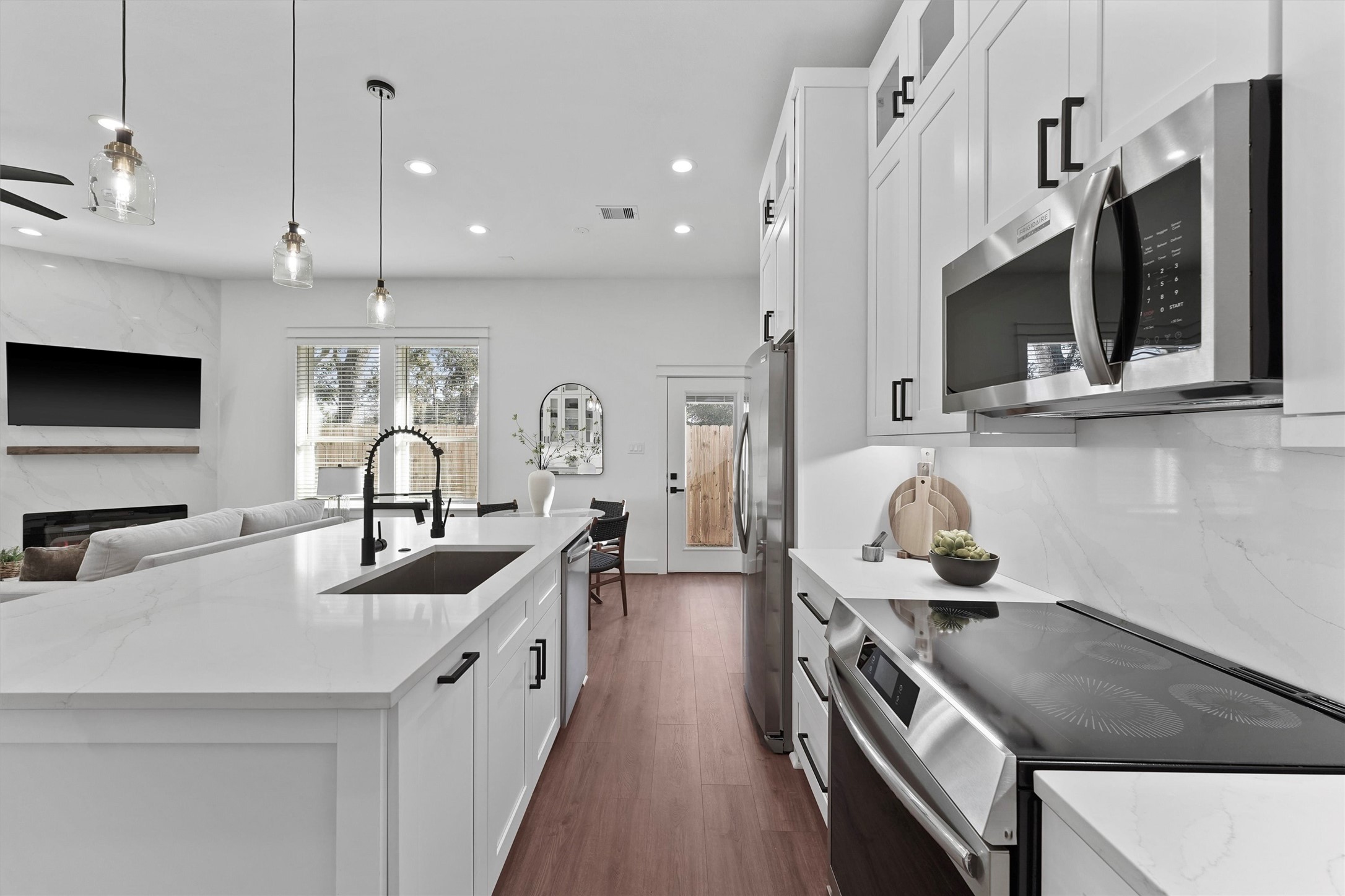 6130 Endeavor Heights Road Houston, TX 77091 - Photo 7 of 33 a kitchen with stainless steel appliances granite countertop a sink a stove and a wooden floors