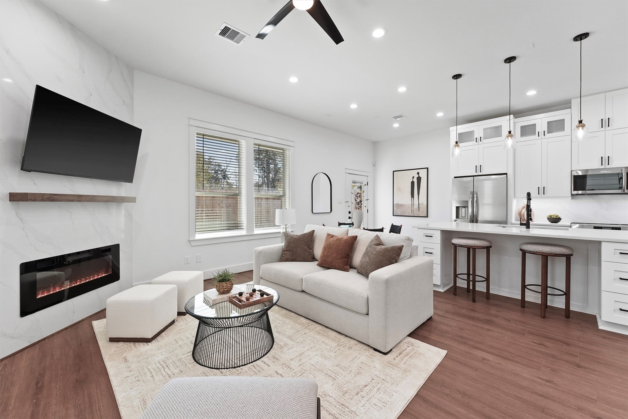 6130 Endeavor Heights Road Houston, TX 77091 - Photo 9 of 33 a living room with furniture fireplace and a flat screen tv