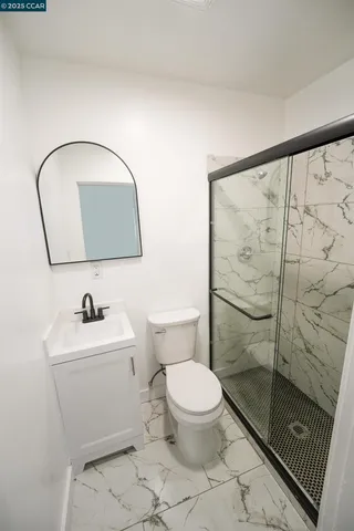 a white toilet sitting next to a bathroom sink