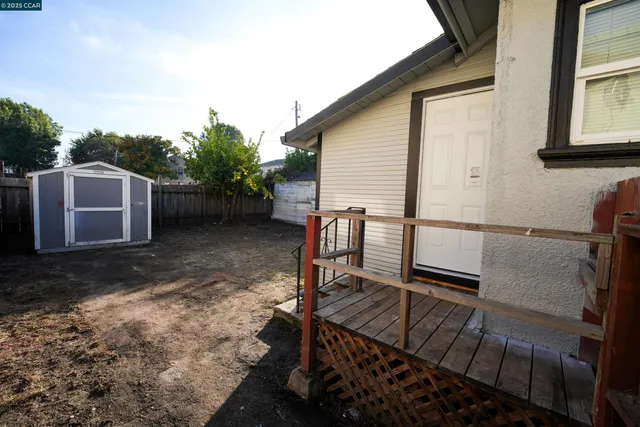 a view of a backyard with chairs and a stove top oven