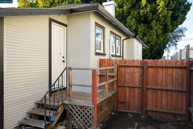 a view of a house with wooden fence