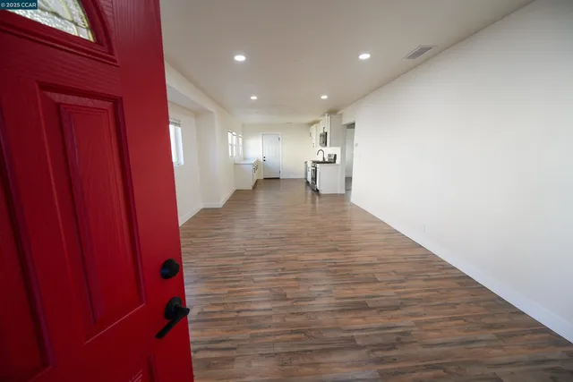 a view of a hallway with wooden floor