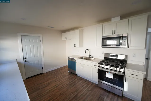 a kitchen with granite countertop a stove and a sink