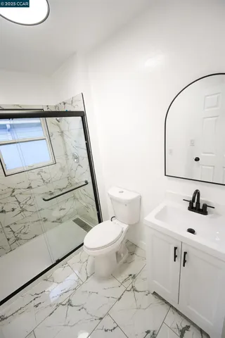 a bathroom with a sink a toilet and a mirror