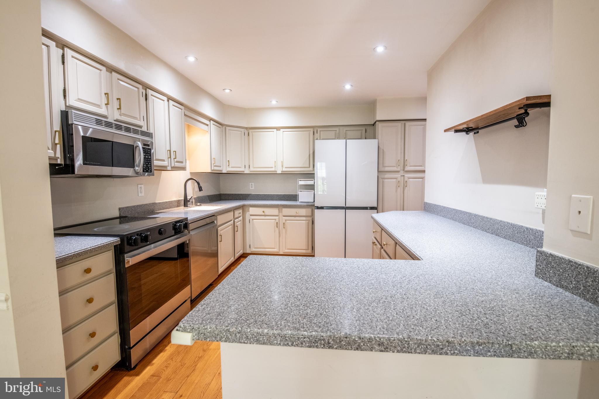 1197 Heyward Road, Unit 35 Chesterbrook, PA 19087 - Photo 11 of 44 a kitchen with stainless steel appliances granite countertop a stove a sink and a refrigerator