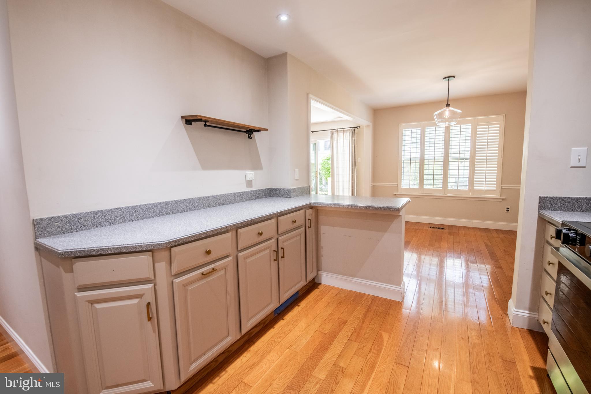 1197 Heyward Road, Unit 35 Chesterbrook, PA 19087 - Photo 13 of 44 a open kitchen with cabinets a sink and wooden floor