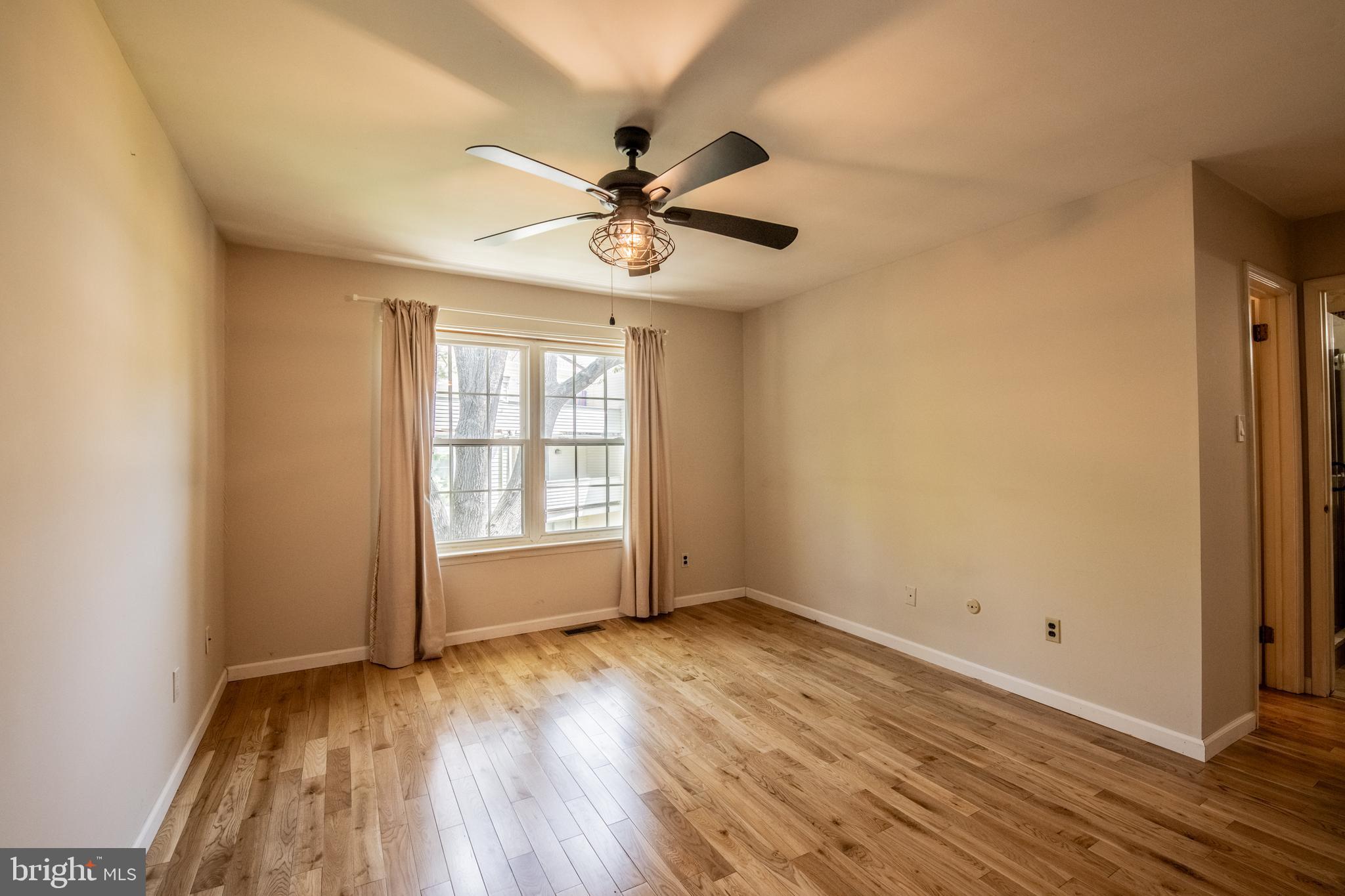 1197 Heyward Road, Unit 35 Chesterbrook, PA 19087 - Photo 20 of 44 a view of an empty room with wooden floor and a window