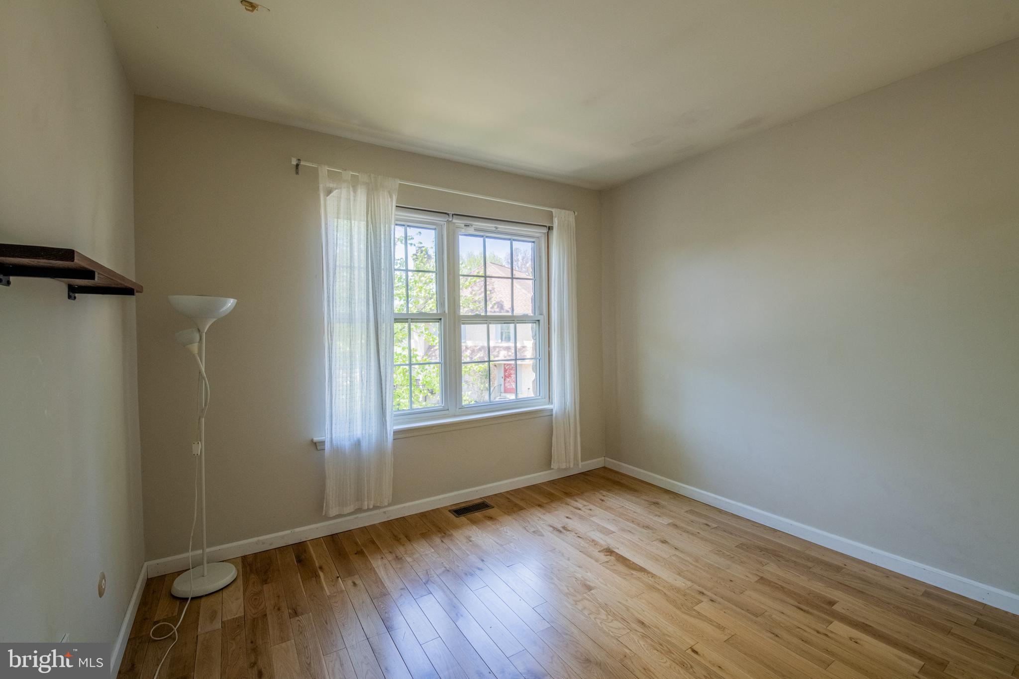 1197 Heyward Road, Unit 35 Chesterbrook, PA 19087 - Photo 25 of 44 an empty room with wooden floor and windows