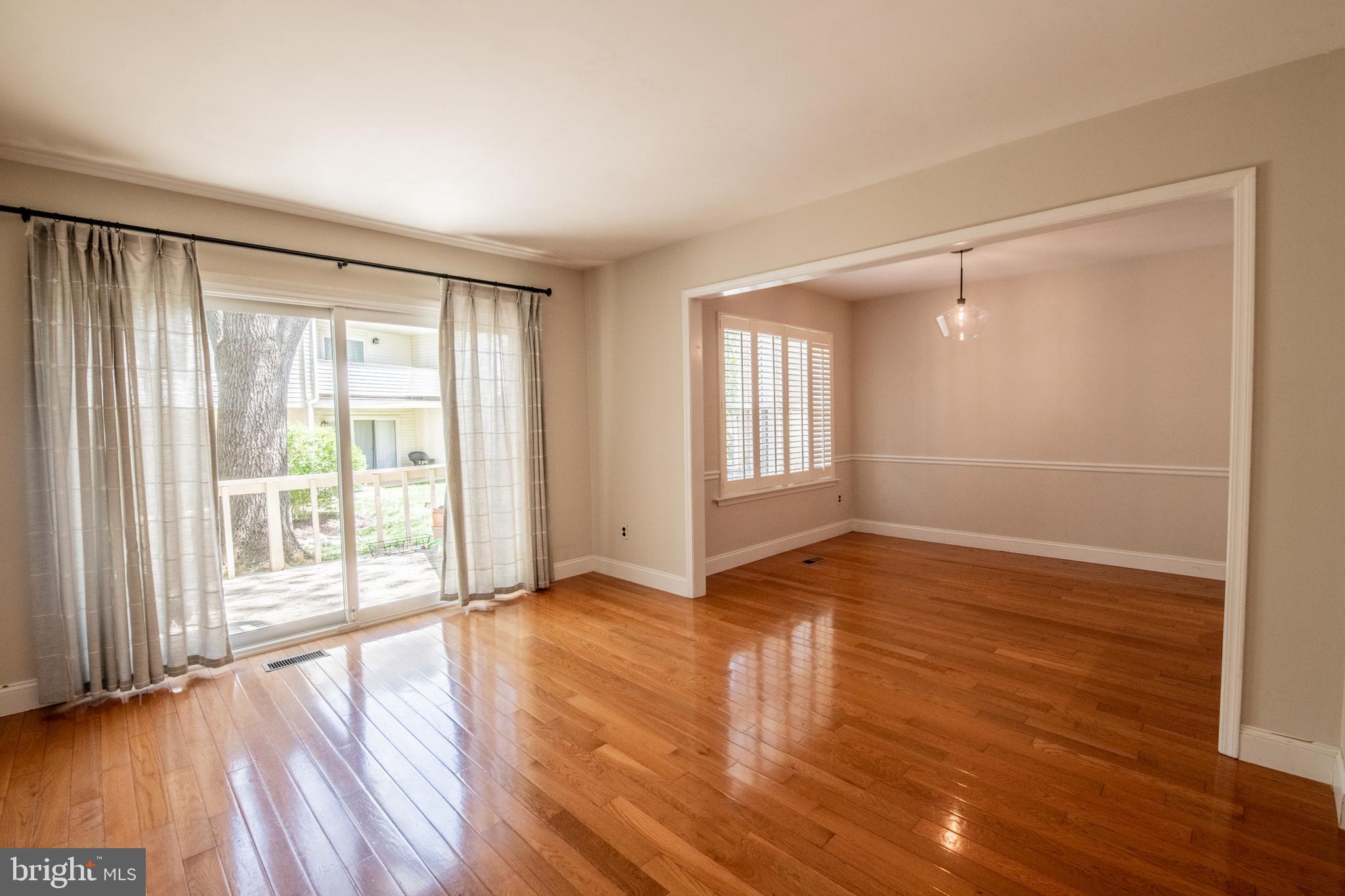1197 Heyward Road, Unit 35 Chesterbrook, PA 19087 - Photo 9 of 44 a view of an empty room with wooden floor and a window