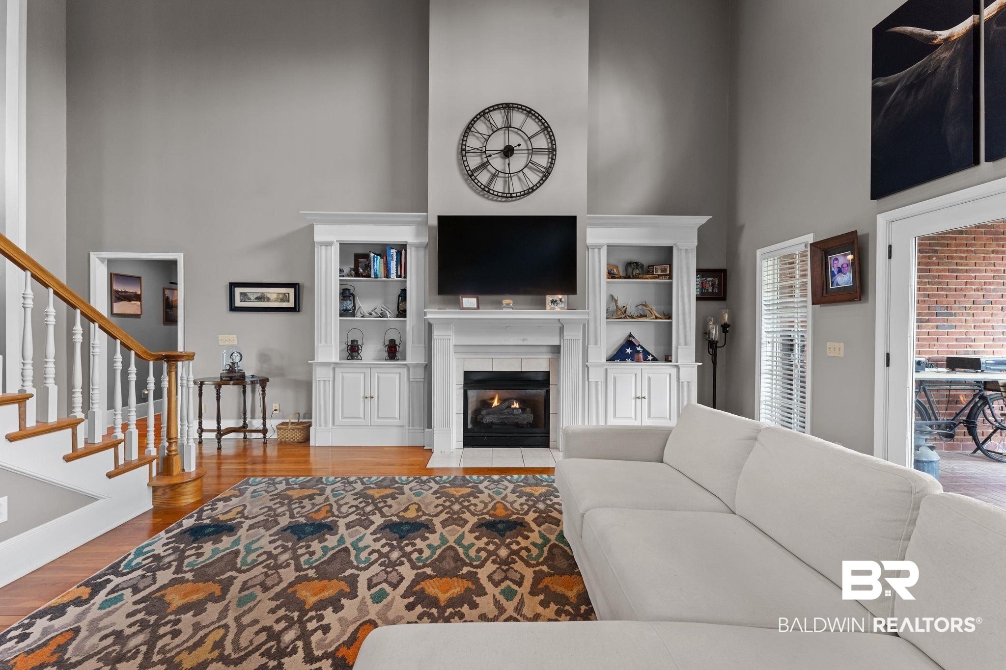 525 Norwood Road Monroeville, AL 36460 - Photo 7 of 55 Living room with a high ceiling, a fireplace, stairway, and wood finished floors