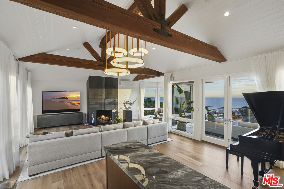 3140 Sweetwater Mesa Road Malibu, CA 90265 - Photo 17 of 71 a living room with furniture and a flat screen tv