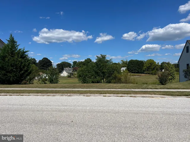 a view of a house and a big yard