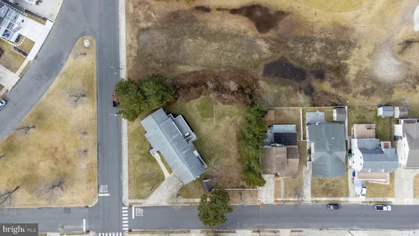a aerial view of a house with a yard and large trees