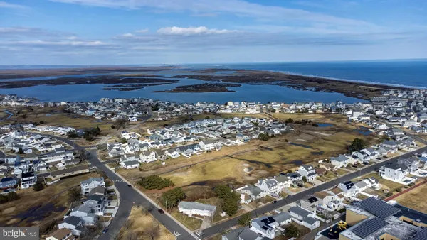an aerial view of residential building and ocean