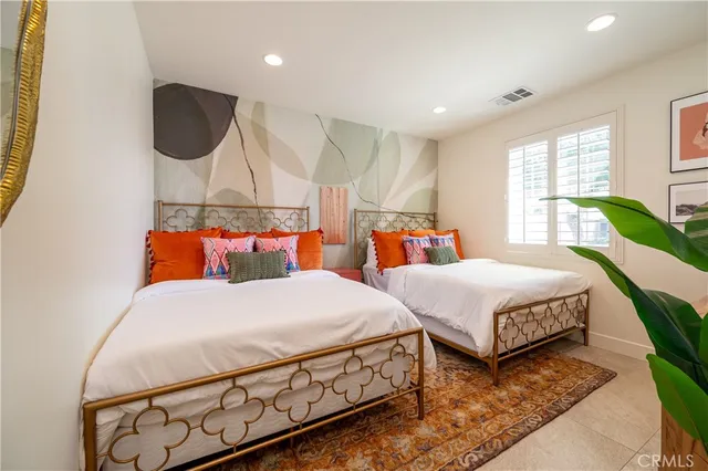 a bedroom with furniture and a potted plant
