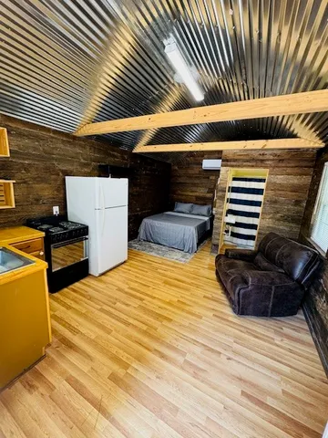 a view of outdoor space with wooden floor and barbeque oven