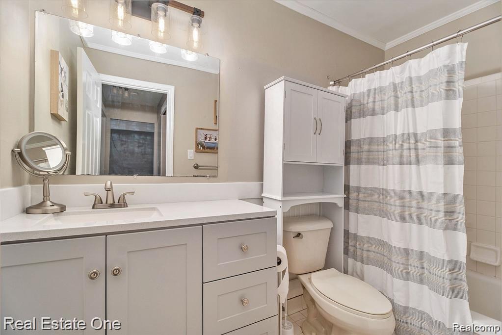803 Plate Street, Unit 104 Rochester, MI 48307 - Photo 8 of 14 Bathroom vanity featuring light gray cabinetry, a white countertop, and an integrated rectangular sink