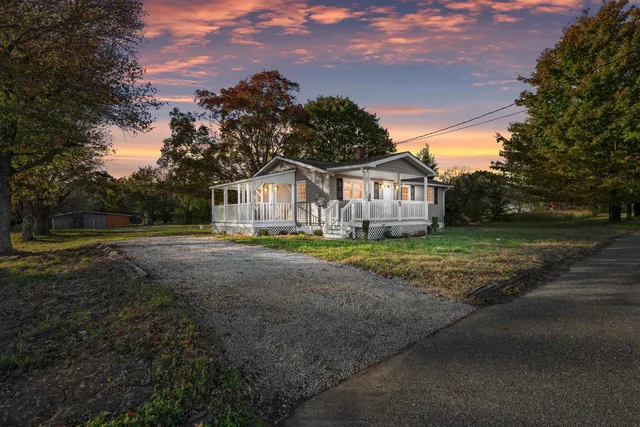 a view of house with yard and green space