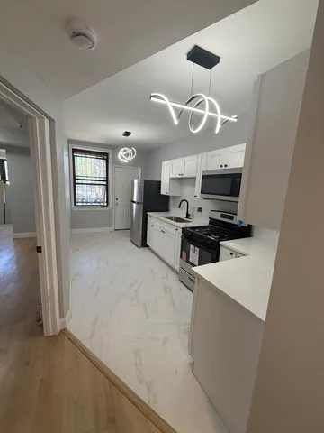 a view of a kitchen with electric appliances