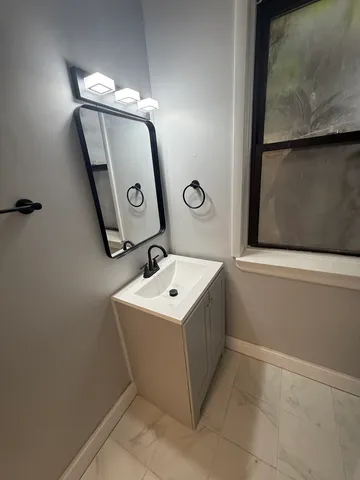 a bathroom with a sink a toilet and mirror