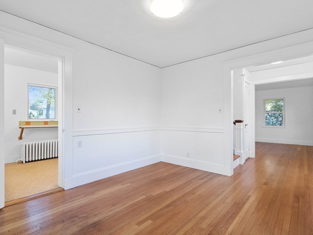 122 Albemarle Road Newton, MA 02460 - Photo 11 of 28 an empty room with wooden floor and white walls
