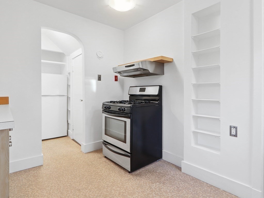 122 Albemarle Road Newton, MA 02460 - Photo 14 of 28 a kitchen with stainless steel appliances a stove and a refrigerator