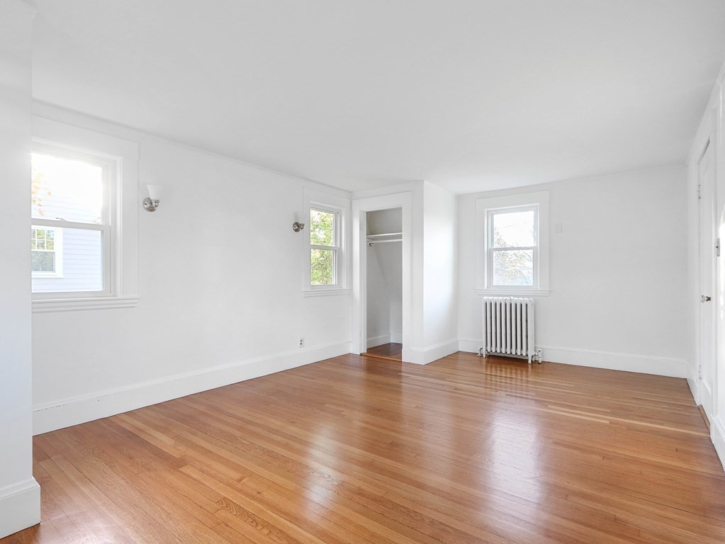 122 Albemarle Road Newton, MA 02460 - Photo 15 of 28 an empty room with wooden floor and windows