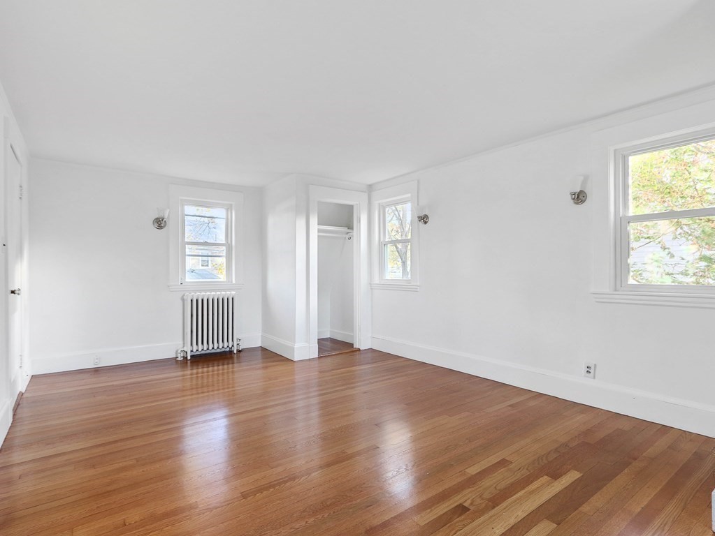 122 Albemarle Road Newton, MA 02460 - Photo 17 of 28 an empty room with wooden floor and windows
