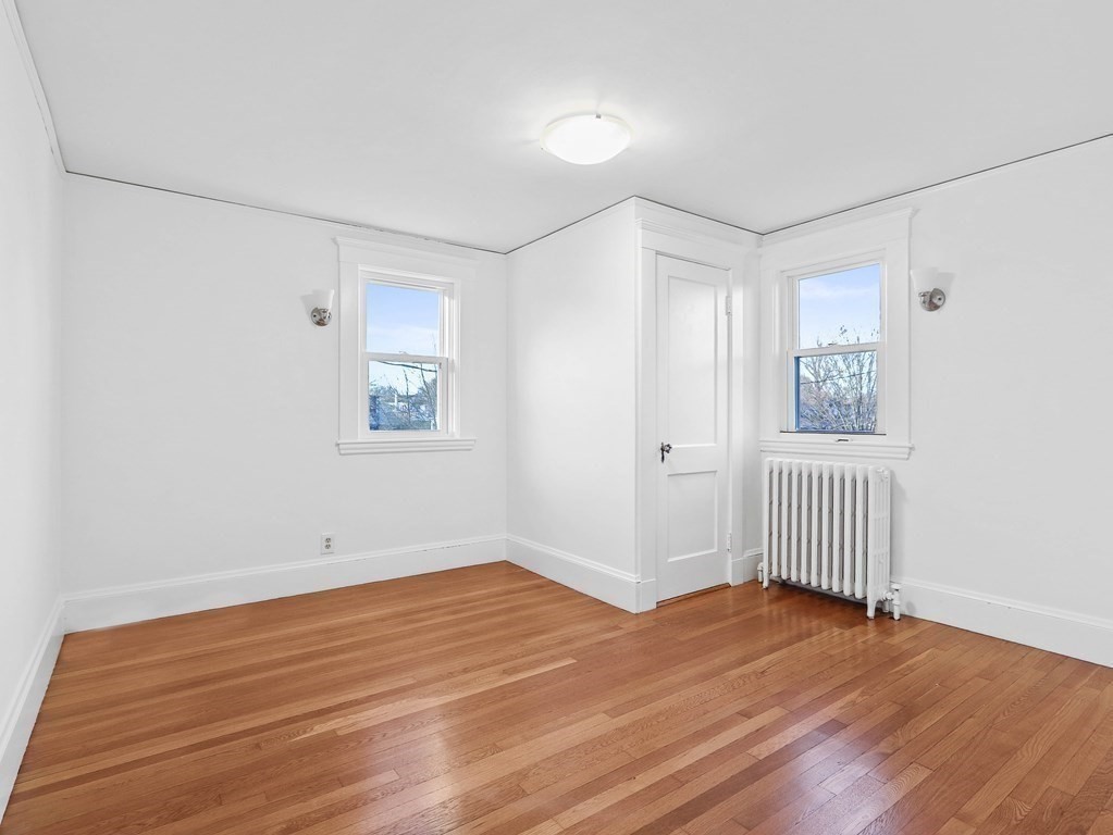 122 Albemarle Road Newton, MA 02460 - Photo 20 of 28 an empty room with wooden floor and windows