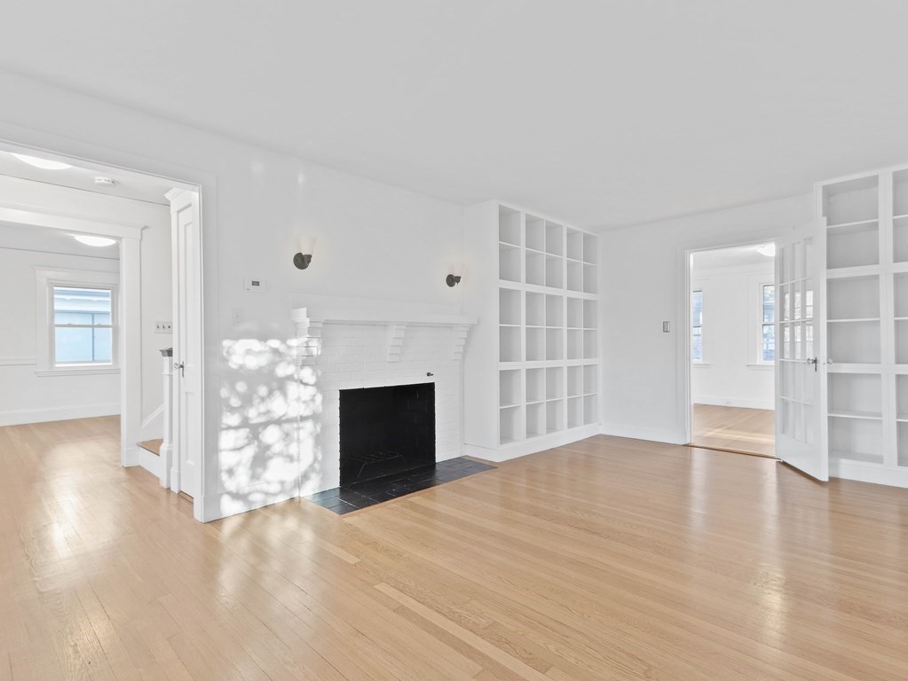122 Albemarle Road Newton, MA 02460 - Photo 4 of 28 a view of empty room with wooden floor and fireplace