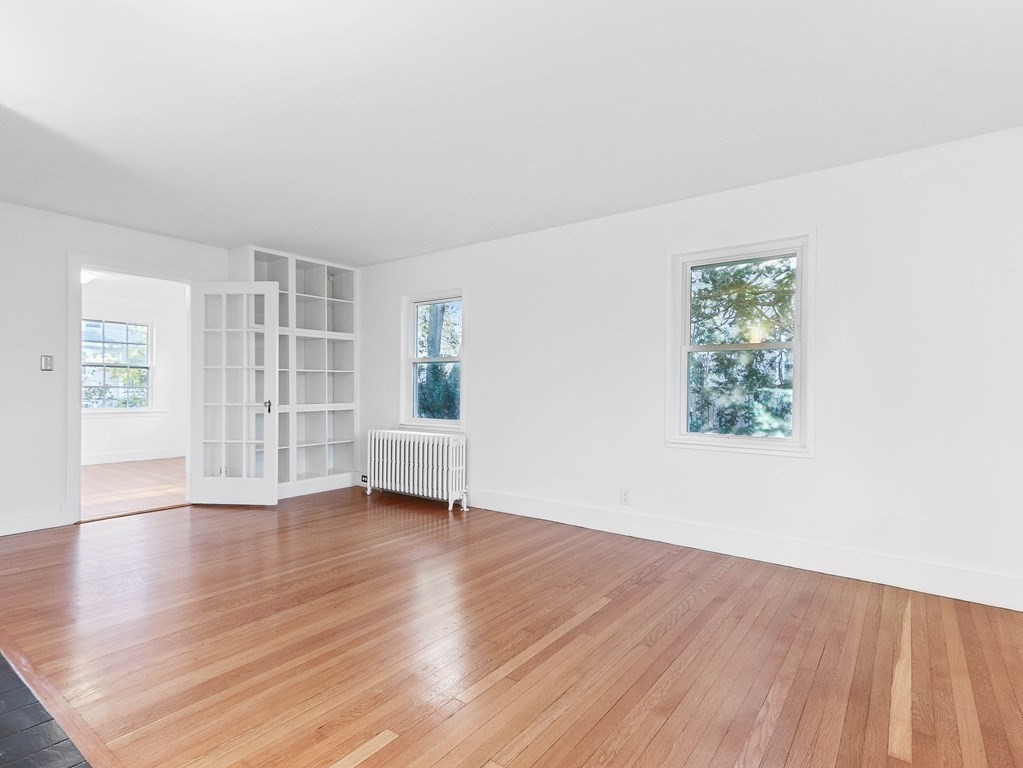 122 Albemarle Road Newton, MA 02460 - Photo 5 of 28 an empty room with wooden floor and windows