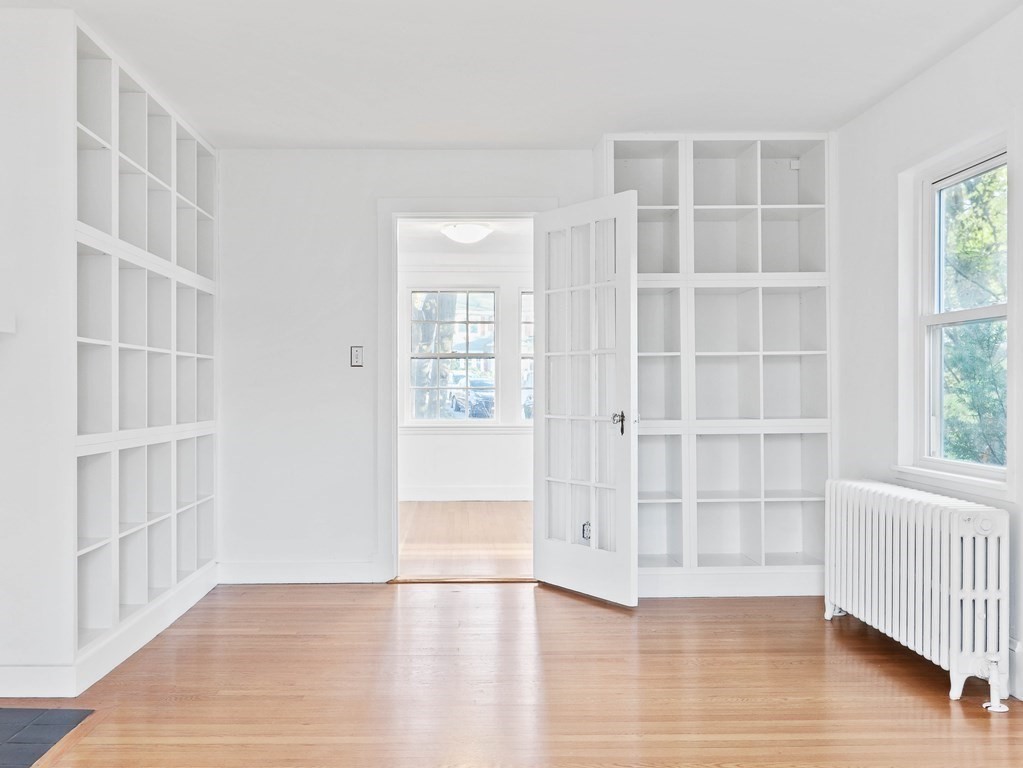 122 Albemarle Road Newton, MA 02460 - Photo 6 of 28 an empty room with wooden floor and windows