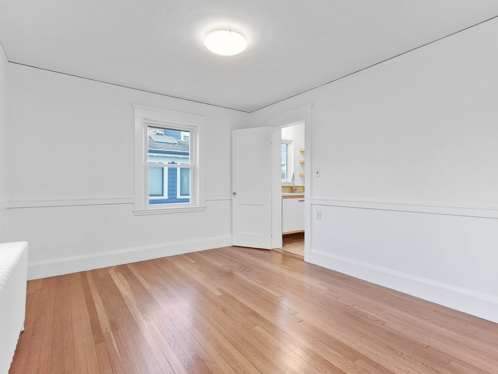 122 Albemarle Road Newton, MA 02460 - Photo 10 of 28 an empty room with wooden floor and windows