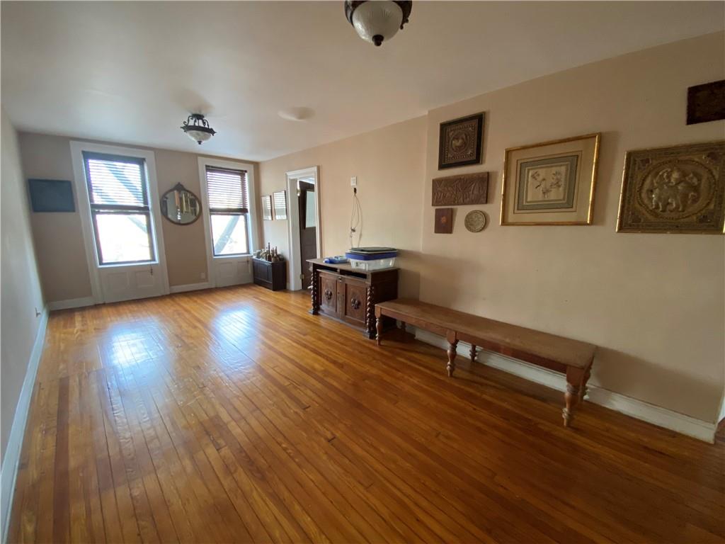 7912 3rd Avenue Brooklyn, NY 11209 - Photo 11 of 18 a view of a livingroom with furniture wooden floor and windows