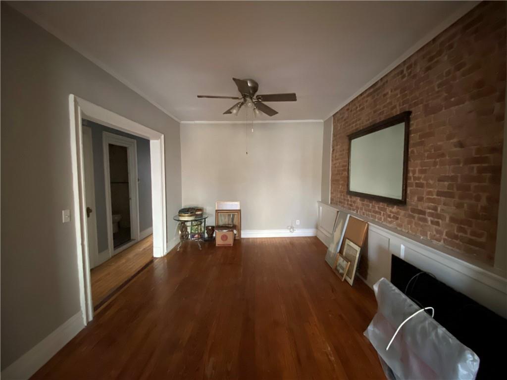 7912 3rd Avenue Brooklyn, NY 11209 - Photo 14 of 18 a living room with furniture and a flat screen tv