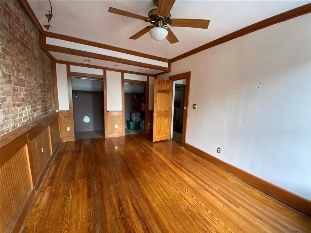 7912 3rd Avenue Brooklyn, NY 11209 - Photo 4 of 18 a view of a room with wooden floor and staircase