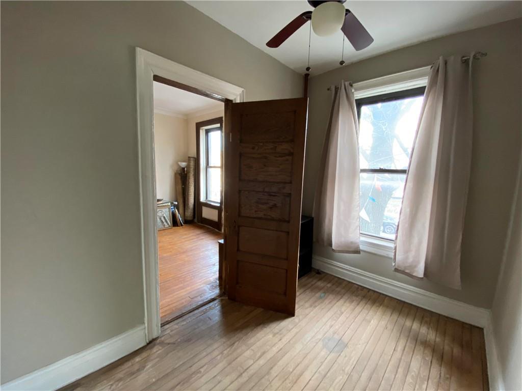 7912 3rd Avenue Brooklyn, NY 11209 - Photo 6 of 18 a view of a hallway with wooden floor and windows