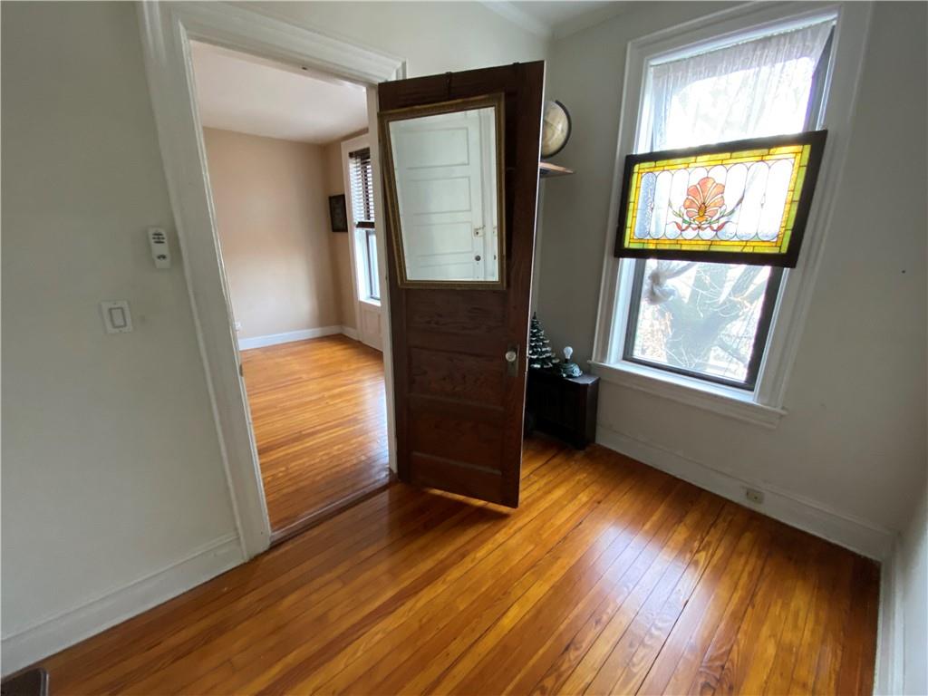 7912 3rd Avenue Brooklyn, NY 11209 - Photo 7 of 18 a view of hallway with window and wooden floor