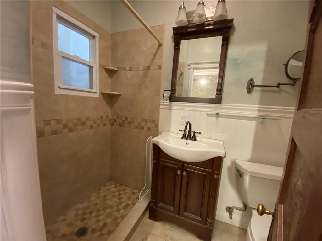 7912 3rd Avenue Brooklyn, NY 11209 - Photo 9 of 18 a bathroom with a sink a toilet and shower