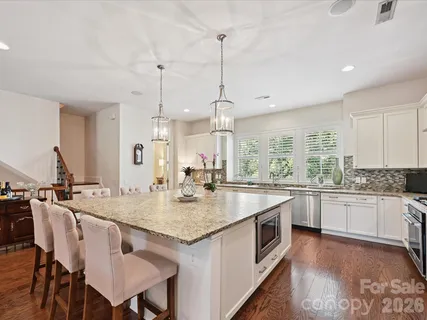 a kitchen with center island table and chairs